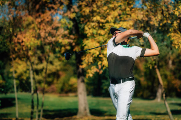 A golf player is putting on green