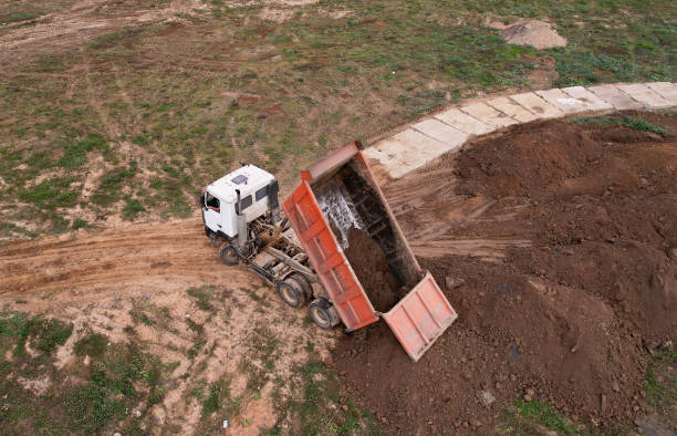 istock Dump truck unloads the ground and sand at construction site. 1353454623