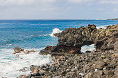 istock Coast Oahu rock arch 1353456593