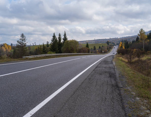 istock Hazy and overcast Carpathian Mountains and highway on mountain pass, Ukraine. 1353456831