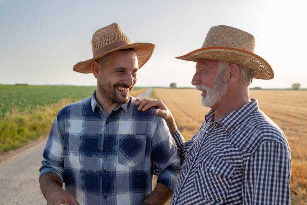 istock Two farmers talking in field 1353457997