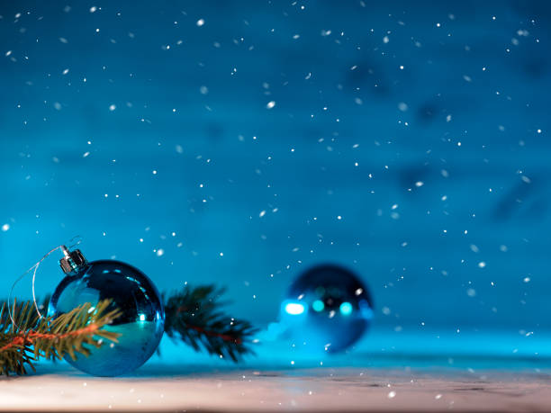 istock Christmas blue background, Christmas tree branch, blue ball, falling snow 1353458261