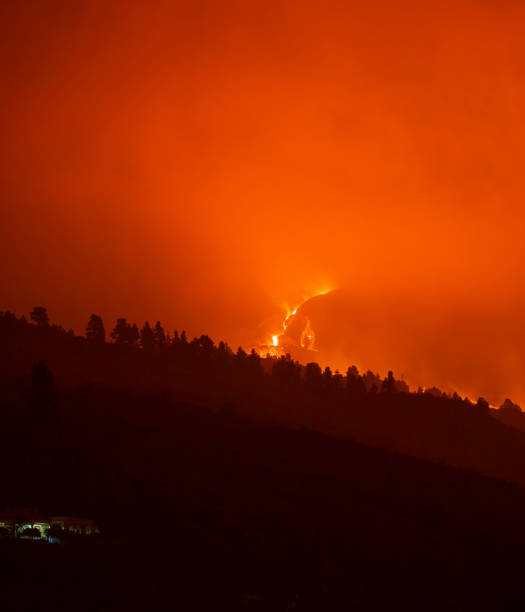 istock Cumbre Vieja's volcano eruption. Volcanic cone and volcanic bombs going dawnhill. 1353459287