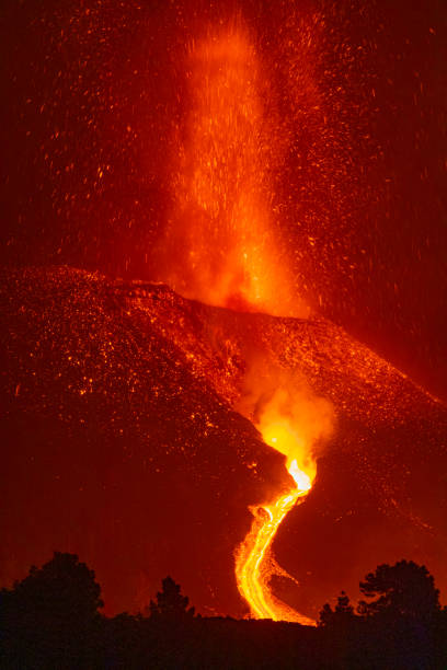istock Cumbre Vieja's volcano eruption. Volcanic cone and volcanic bombs going dawnhill. 1353459332