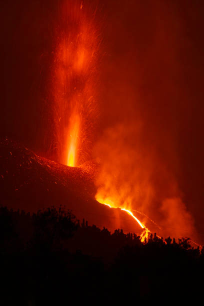 istock Cumbre Vieja's volcano eruption. Volcanic cone and volcanic bombs going dawnhill. 1353459384