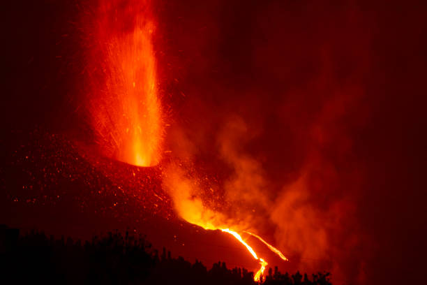 istock Cumbre Vieja's volcano eruption. Volcanic cone and volcanic bombs going dawnhill. 1353459408