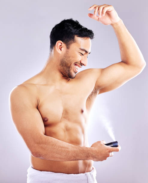 istock Studio shot of a handsome young man applying deodorant to his underarms 1353459810