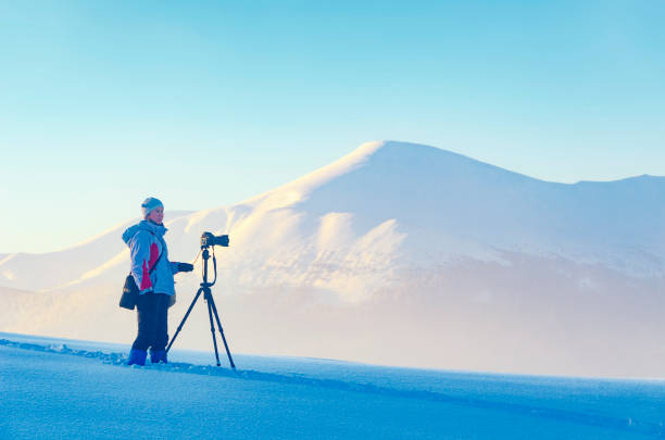 istock Winter landscape photographer at work. 1353459975