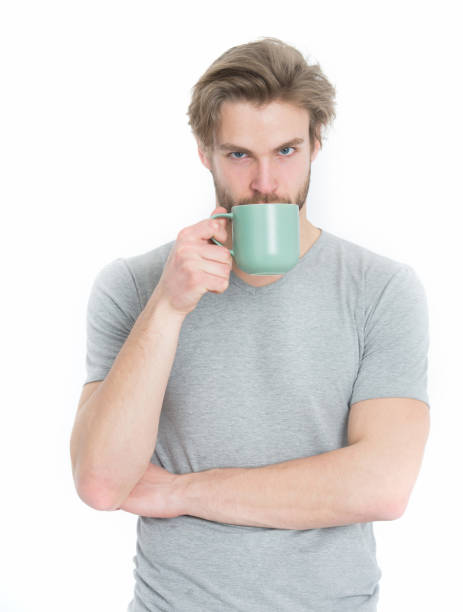 istock man drink from coffee or tea cup 1353460597