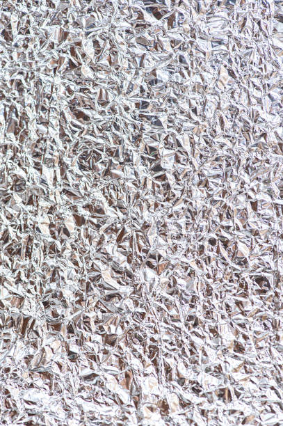 istock Crumpled abstract silver background. Vertical photo 1353461127