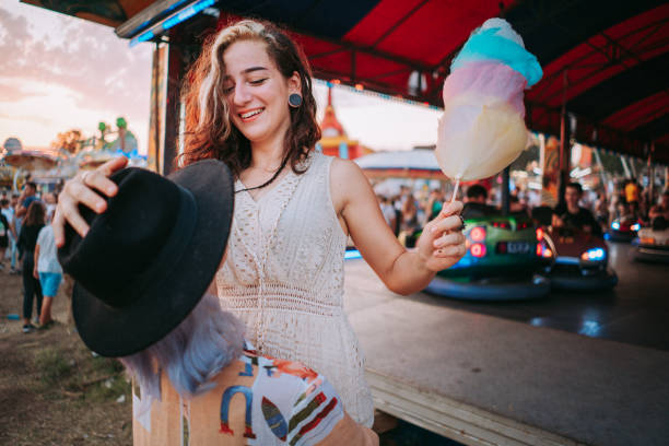 istock Happy girlfriends are make fun together in fun fair 1353470574