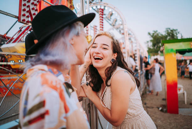 istock Happy girlfriends making fun together in a fun fair 1353470750