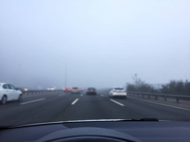 istock Driving in traffic on a foogy day 1353470991