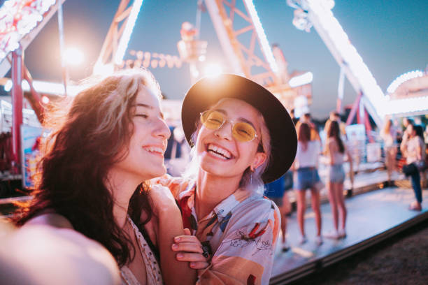 istock Couple taking selfies at a fair 1353471045