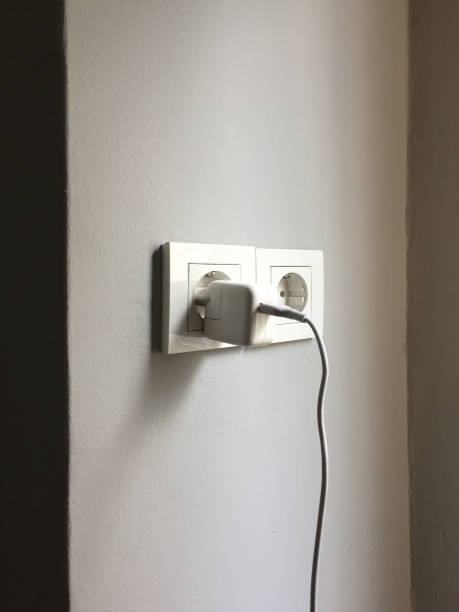 istock Charger in the electric plug 1353471634