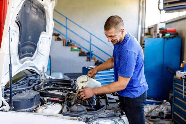 istock A Car Maintenance Man is Checking Motor Oil in Auto Service. 1353472122