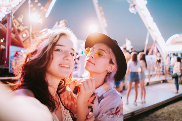 istock Couple taking selfies at a fair 1353472137