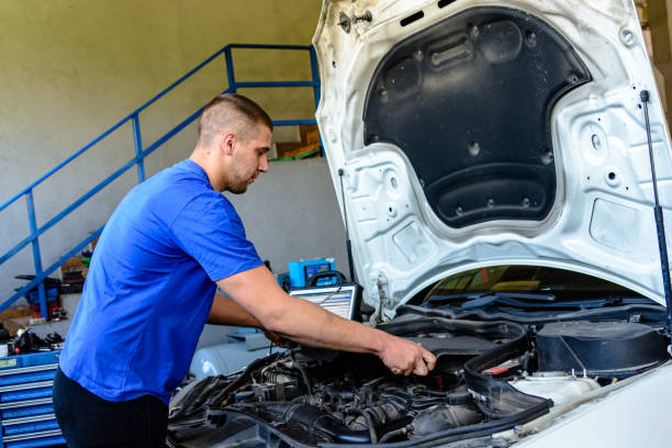 istock A Car Mechanic is Fixing the Mechanic Problems on the Car in a Mechanic Workshop. 1353472149