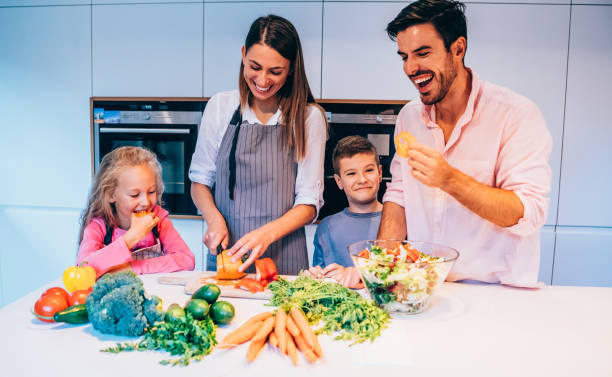 istock Happy family cooking together. 1353472321