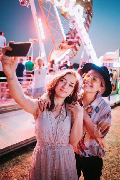 istock Couple taking selfies at a fair 1353472563
