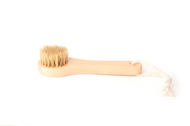 istock Wooden massage brush for face and body with natural bristles isolated on white background. Body care and spa treatments. 1353473257