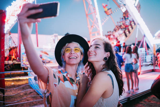 istock Couple taking selfies at a fair 1353474397