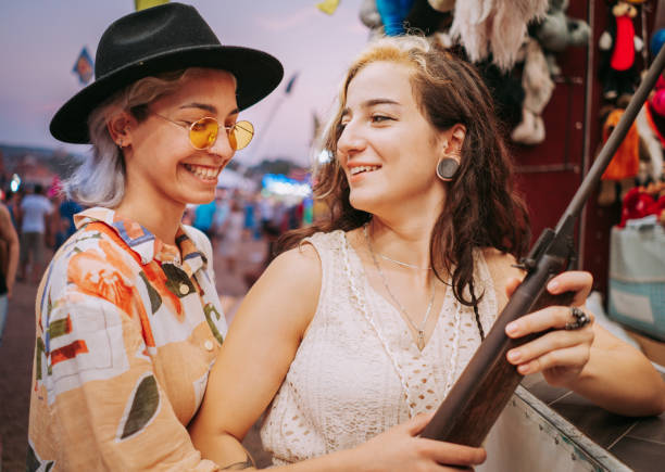istock Smiling women in target shooting tent 1353474519