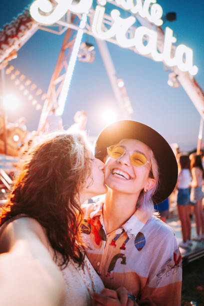 Couple taking selfies at a fair stock photo