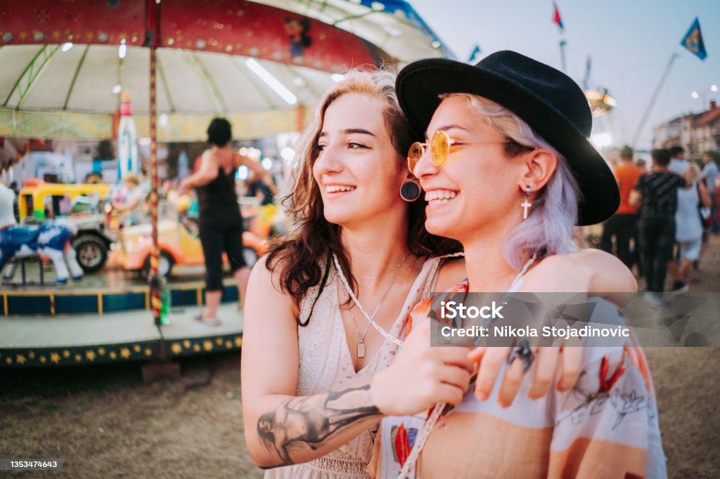 Smiling women in target shooting tent Music Festival Stock Photo