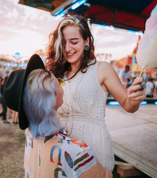 istock Happy girlfriends making fun together in a fun fair 1353474644