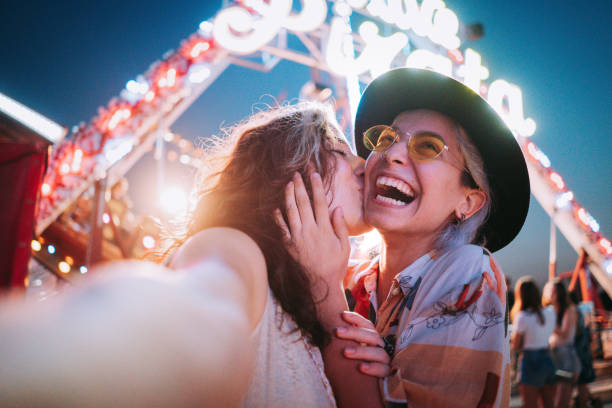 istock Couple taking selfies at a fair 1353475438