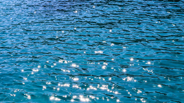 istock Blue sea in sunshine glow as surface background. Summer holidays concept 1353475528