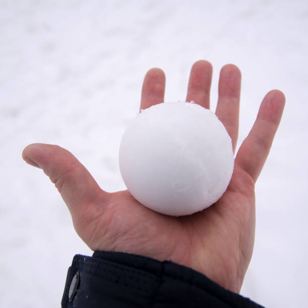 istock snowball in bare hand. snowball melts in bare hand 1353475612