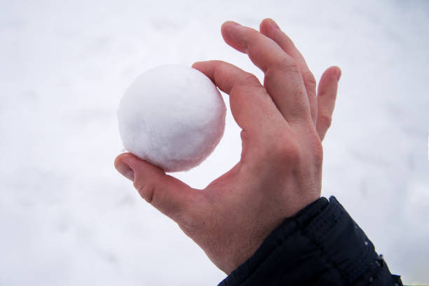 istock Perfect snowball in bare hand. snowball melts in bare hand 1353475640