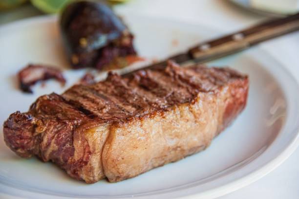 traditional delicious grilled argentine barbecue steak on white plate close up with blurred background. - 2127 imagens e fotografias de stock