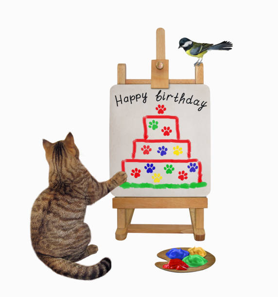 istock Cat artist draws birthday cake 1353477100