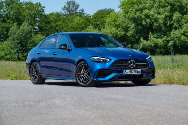 mercedes-benz c-class on a road - capital letter luxury blue image imagens e fotografias de stock