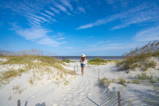 istock Girl walking on the beautiful white sand beach. 1353477910