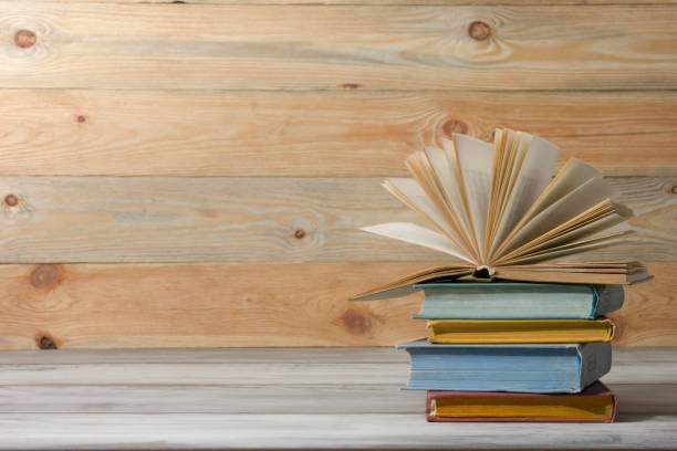 istock Open book, hardback books on wooden table. Back to school. Copy space. 1353478246