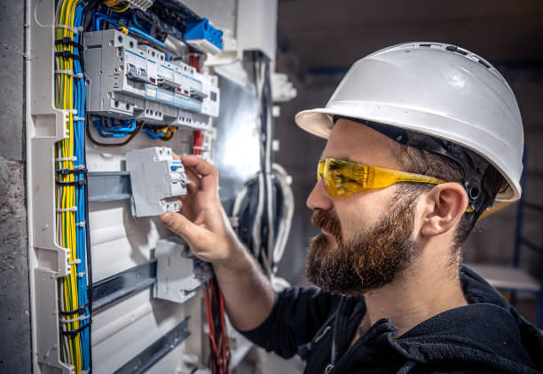 istock A male electrician works in a switchboard with an electrical connecting cable. 1353480184