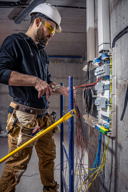 istock A male electrician works in a switchboard with an electrical connecting cable. 1353480195