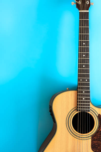 istock Acoustic guitar on a blue background, top view, copy space. 1353482267
