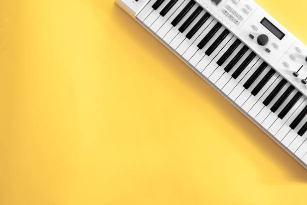 istock Musical background with musical keys on yellow, flat lay, copy space. 1353482284