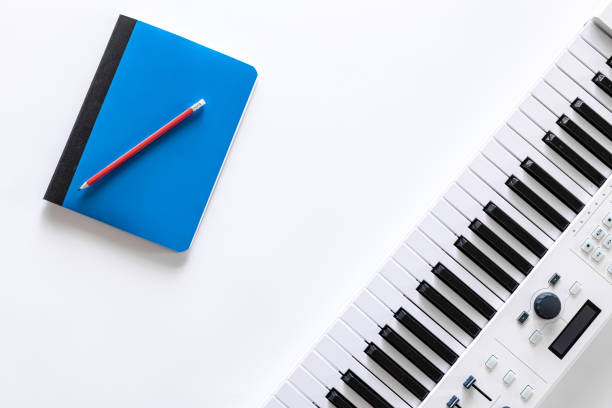 istock Musical keys and notepad on white background, flat lay. 1353482287