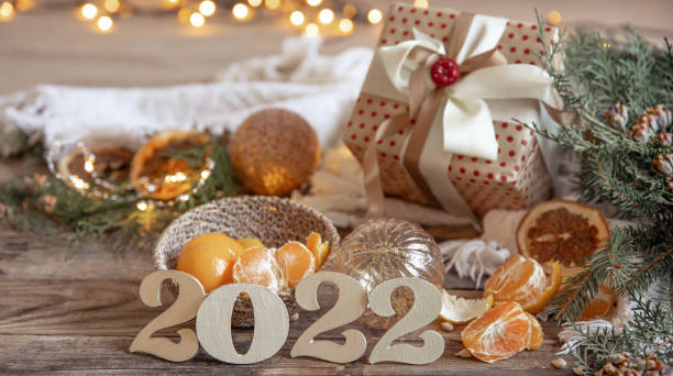 istock Christmas composition with decorative numbers 2022, mandarins and decor details. 1353482553