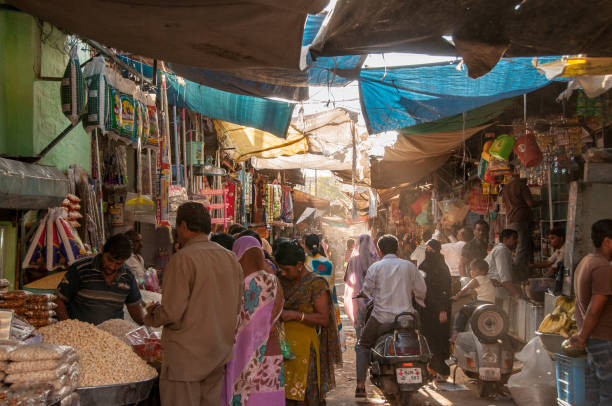 In the streets of the busy market of Jodhpur Jodhpur, Rajasthan, India - oct 17, 2011 : lots of people, scooters and all sorts of merchandise in the narrow streets of Jodhpur india indian culture market clothing stock pictures, royalty-free photos & images