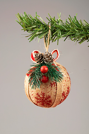 Christmas ball hanging on a fir tree branch