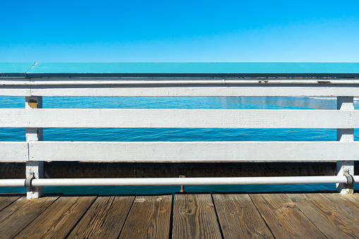 Pier railing with ocean and sky in San Clemente, California
