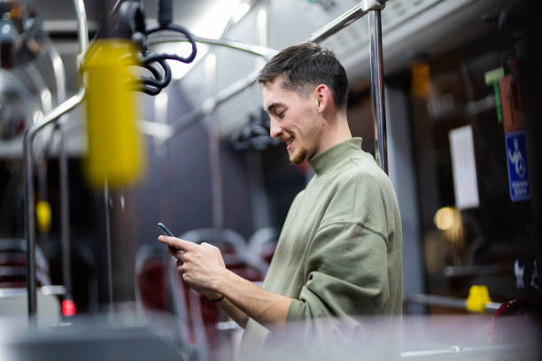 istock Young handsome man using phone in public transportation 1353495026