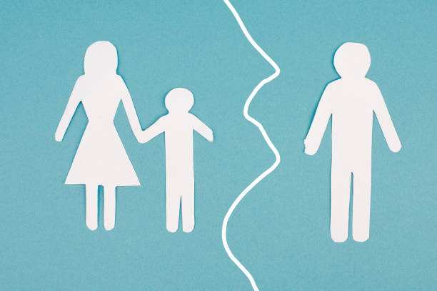 Divorced parents, child with mother, father alone, single mum, custody fight, paper cut out, blue background stock photo